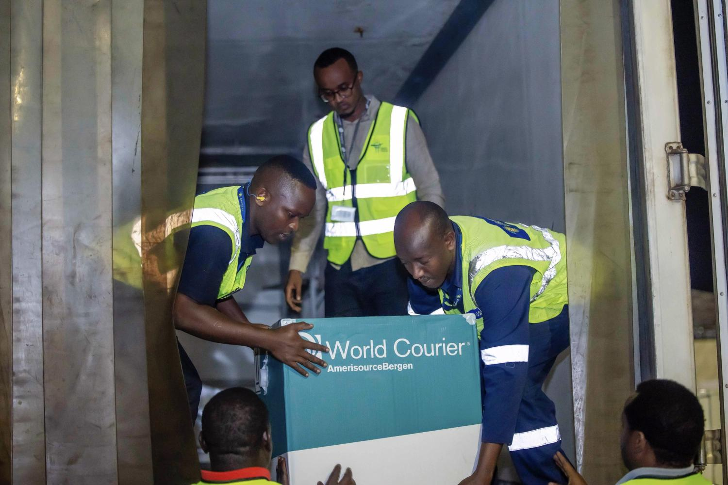 Workers moving a box